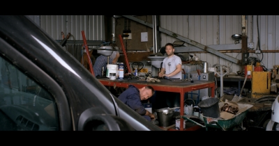 Director-Mark-Murphy-making-a-cameo-as-a-mechanic-with-Joe-Adrian-Bouchet-©-2014-Family-Dies-Ltd